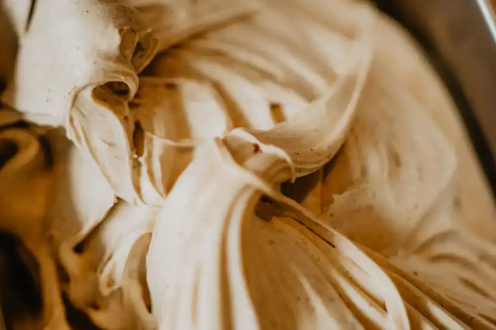 Close up of freshly churned creamy artisan gelato in a metal pan